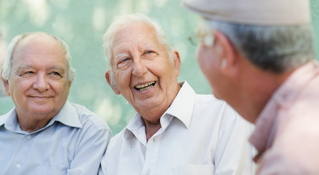 Group of happy elderly men laughing and talking